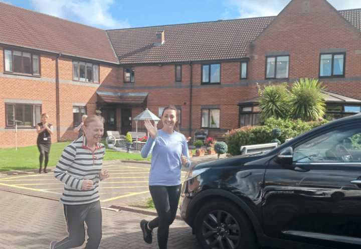 Caroline and Alex running outside Archers Court Dementia Care Home